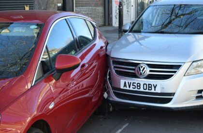 Photo by Usman Malik two cars parked next to each other in a parking lot